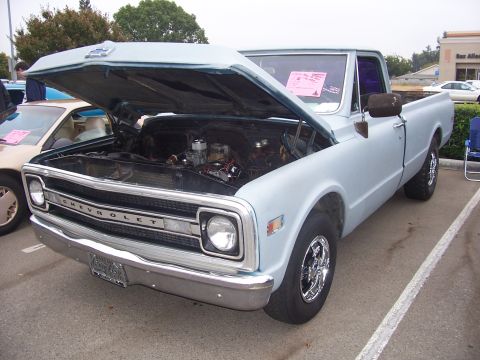 2002 Ford Mustang - This light blue Chevrolet pickup truck, likely from 1967, is displayed with its hood open, revealing the engine compartment.