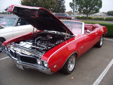 2002 Ford Mustang - 1969 Oldsmobile 442 convertible on display, showing its engine bay.