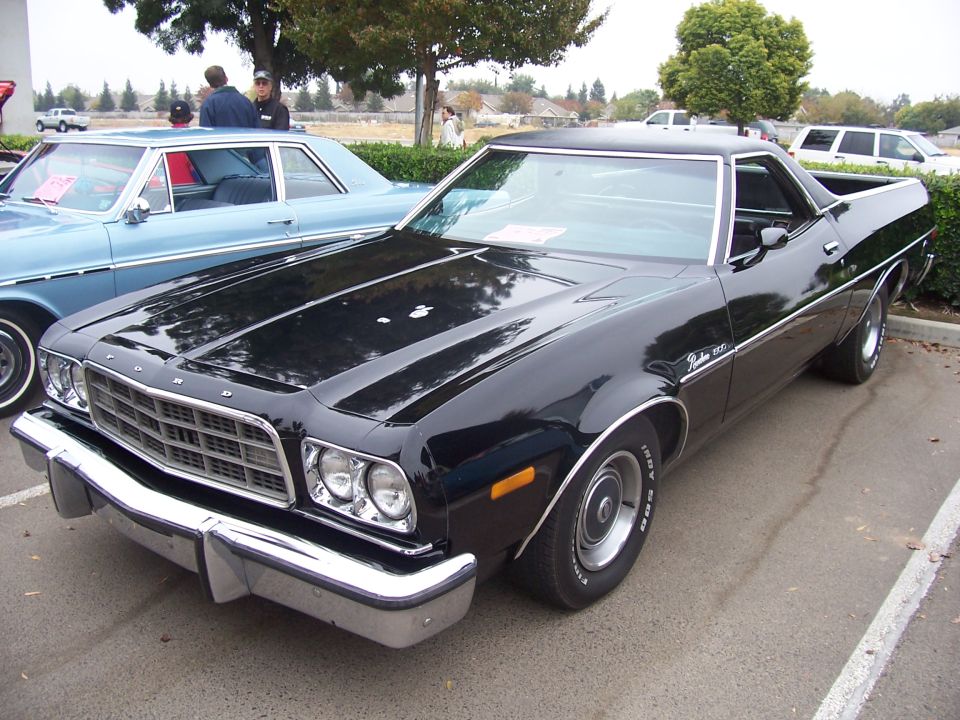 Black 1977 Ford Ranchero parked, front quarter view, chrome bumper, grille, and trim