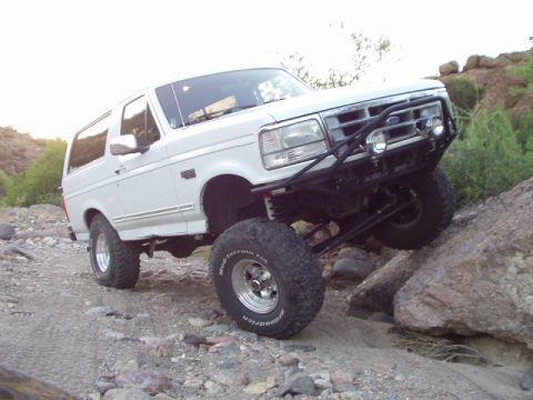 1993 Ford Bronco - This lifted 1993 Ford Bronco navigates a , rocky landscape.