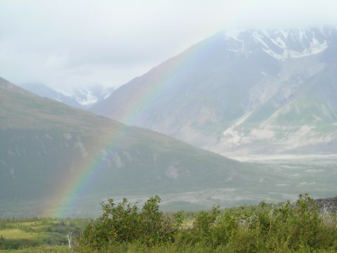 2003 Jeep TJ - A vibrant rainbow stretches across a misty mountain landscape after a rain shower.