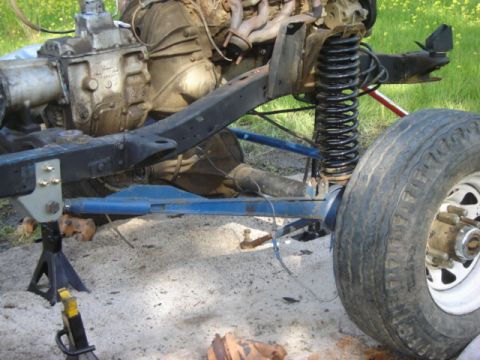 1974 Ford F-100 - Close-up view of a vehicle's undercarriage, showing the engine and suspension system.