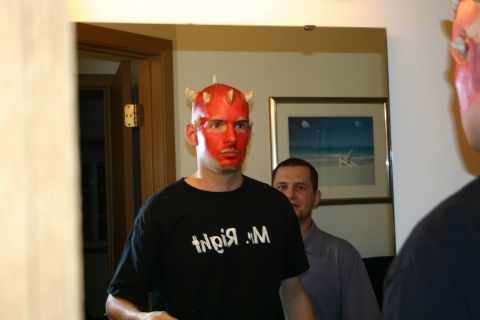 1995 Ford Probe - A man dressed as a devil poses in a mirror, with another person in the background.