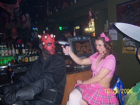 1995 Ford Probe - Two people in costumes are at a bar, one holding a toy gun.