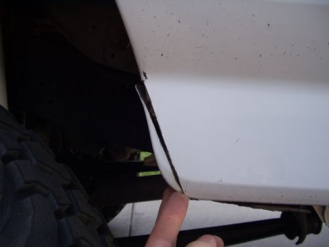 1993 Ford Bronco - Close-up view of the wheel well area on a 1993 Ford Bronco, highlighting the body panel gap.