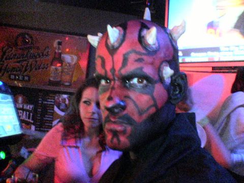 1995 Ford Probe - A person dressed as Darth Maul poses for a photo in a dimly lit establishment.