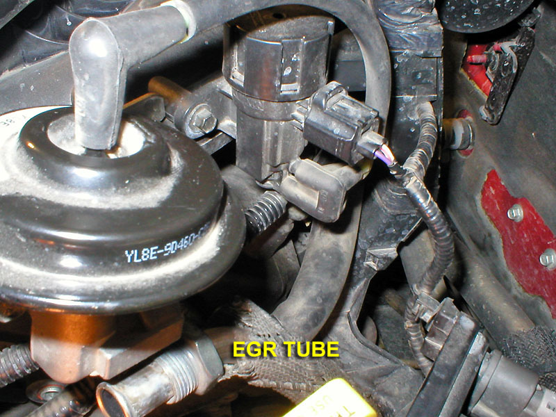 EGR valve and EGR tube on engine, part number YL8E-9D460 visible