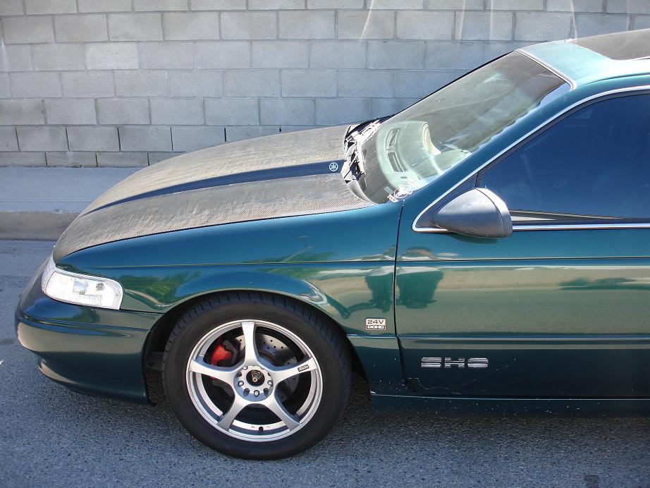 Green 1993 Ford Taurus SHS side view with aftermarket wheels and red brake calipers