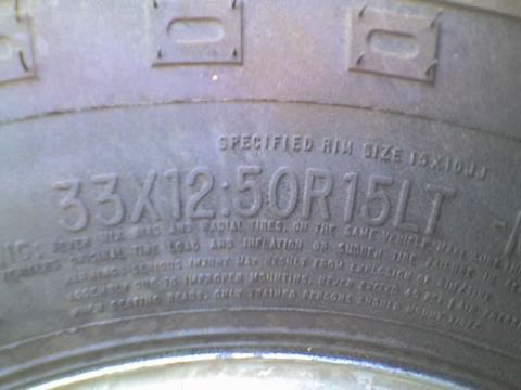 1989 Ford Bronco - Close-up of a tire sidewall showing size and rim specifications.