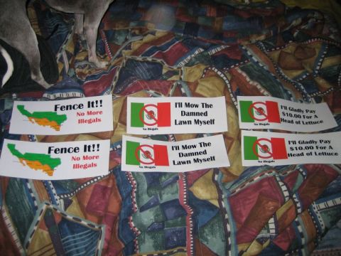 1986 Ford F-150 - A variety of bumper stickers with political messages are displayed on a patterned surface.