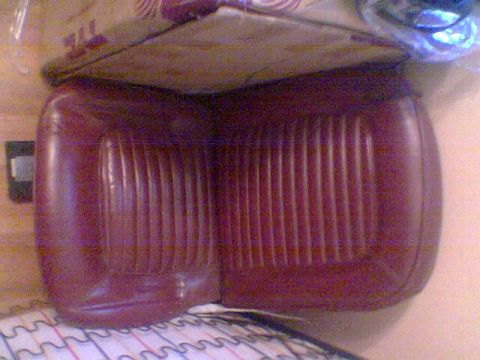 1969 Ford F-250 - A red vinyl seat cushion with vertical pleats is shown, with the Supermotors.net logo visible at the bottom right.