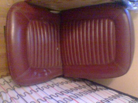 1969 Ford F-250 - Close-up of a maroon vinyl car seat cushion, showing its ribbed texture.