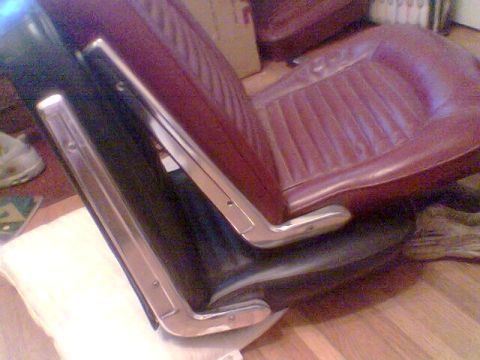 1969 Ford F-250 - Close-up of two car seats, likely from an older vehicle, with visible chrome accents.