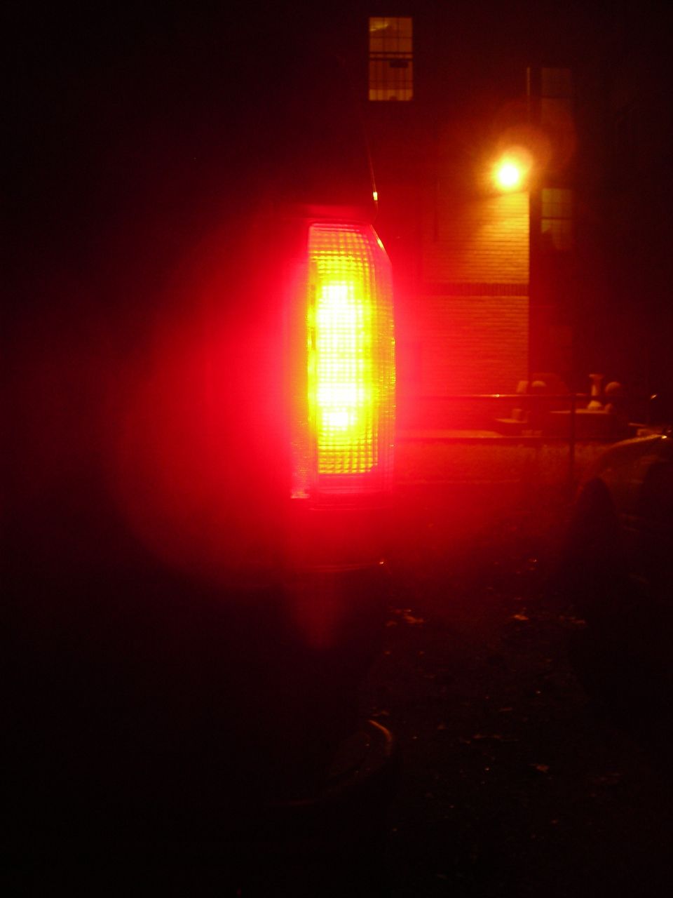 Red tail light on a 1995 Ford Bronco, illuminated with yellow LEDs