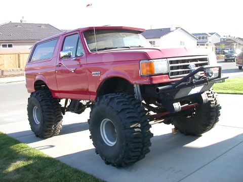 1974 Ford F-100 - This heavily modified Ford Bronco features a significant lift kit and massive off-road tires, giving it an imposing stance.