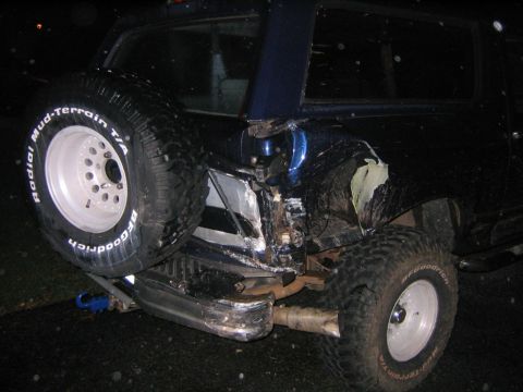 1994 Ford Bronco - This 1994 Ford Bronco has significant rear-end damage and a spare tire mounted externally.