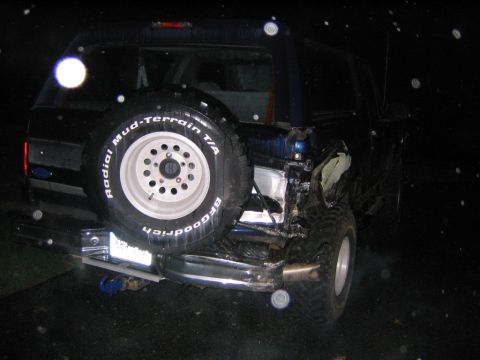 1994 Ford Bronco - This SUV has significant rear-end damage, with the spare tire still mounted on the back.
