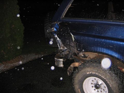 1994 Ford Bronco - Rear quarter panel of a 1994 Ford Bronco shows significant damage after an incident.