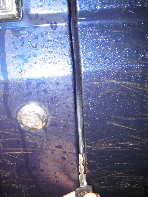 1994 Ford Bronco - Key inserted into the door seam of a 1994 Ford Bronco.