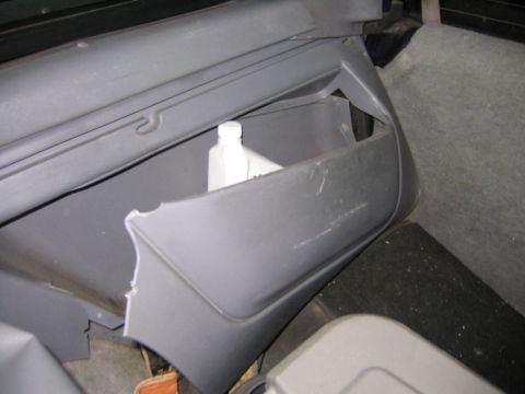 1994 Ford Bronco - A close-up view of a damaged interior storage compartment in a vehicle.