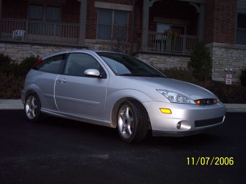 2003 Ford Focus - This silver 2003 Ford Focus hatchback was photographed in front of a brick apartment building.