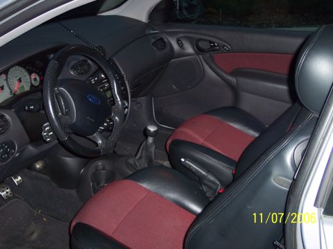 2003 Ford Focus - The interior of a 2003 Ford Focus is shown, two-tone seats and a dashboard with visible gauges.