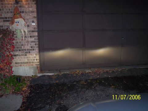 2003 Ford Focus - Headlights are on in front of a closed garage door at night. The date is 11/07/2006.