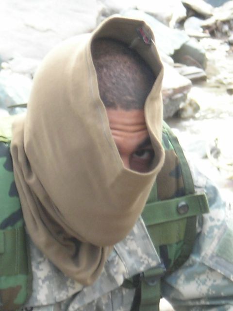 2003 Jeep TJ - A person in military attire with a hood covering their face is visible in the frame.