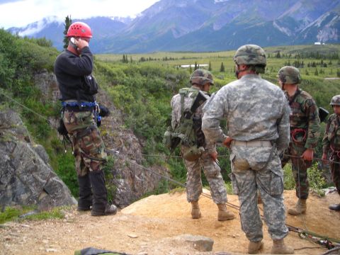 2003 Jeep TJ - Soldiers prepare for an activity on a cliff overlooking a valley with mountains.