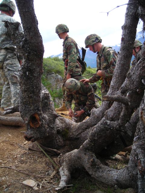 2003 Jeep TJ - Military personnel practice rappelling techniques in a , outdoor environment with mountainous terrain visible in the background.