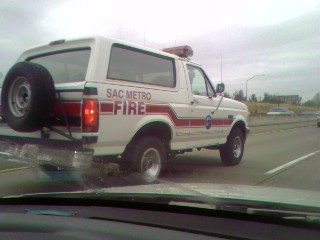 1989 Ford Bronco - This Sac Metro Fire vehicle, a Ford Bronco, is seen on the highway. The year is not discernible from the image.