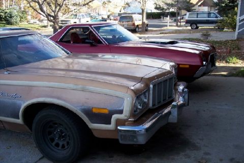 1972 Ford Ranchero - Two Ford Rancheros are parked side-by-side, one in brown and the other in red.