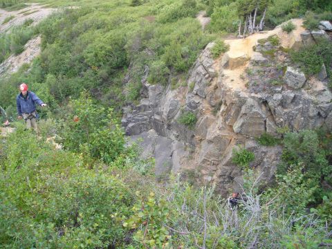 2003 Jeep TJ - Two individuals are present in a , vegetated outdoor environment with a prominent rock formation.