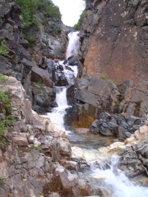 2003 Jeep TJ - A multi-tiered waterfall flows over rocks in a natural gorge.