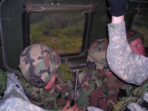 2003 Jeep TJ - Soldiers are seen inside a vehicle, with foliage visible through the window.