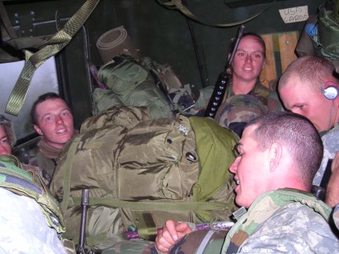 2003 Jeep TJ - Military personnel and equipment are tightly packed inside a vehicle during transport.
