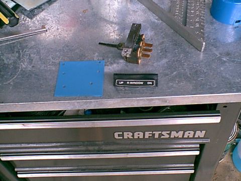 1983 Ford Bronco - Here are the parts. stock Ford Tailgate window switch, Buick station wagon switch cover and a cunk of scrap metal.