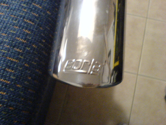 Chrome exhaust tip with 'Borla' logo embossed on it