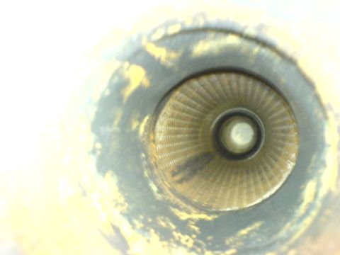 2005 Dodge SRT-4 - Close-up view of a vehicle's exhaust pipe opening, showing internal structure and wear.