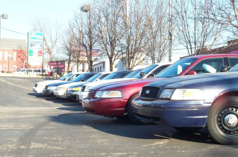 2001 Ford Crown Victoria - Several Ford Crown Victoria police cars are lined up in a parking lot under a clear sky.