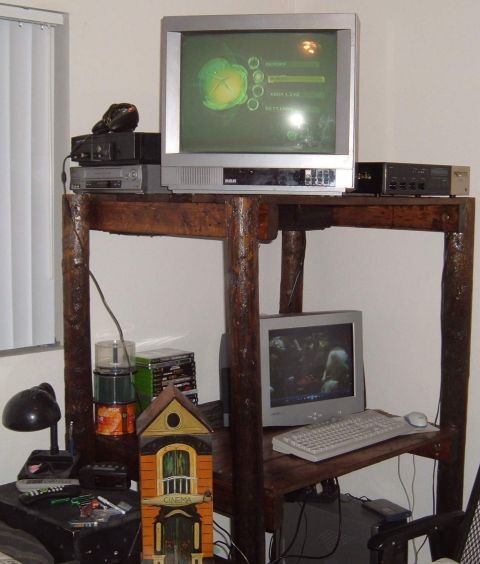 2006 Ford E350 - A collection of electronic devices, including televisions and a computer, are arranged on a rustic wooden table.