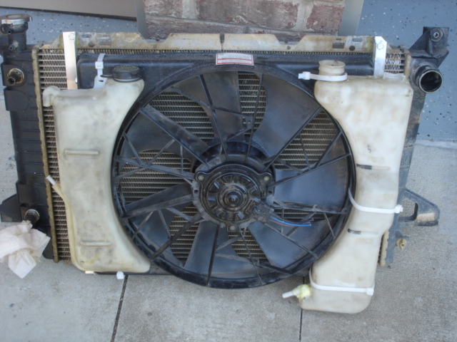 This is the fan.  Its out of a V8 T-bird.  The left reservior is out of a 1989 Town Car and the right rexervior is out of a 1994 Mustang.  They are mounted with HVAC zipties, the really heavy duty kind.