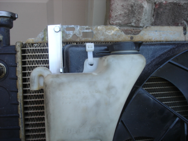 The upper mounting on the town car reservior.