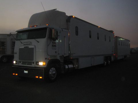 1990 Ford Bronco - white cabover semi truck towing sleeper trailers sits parked at dusk with headlights on and KING KONG lettering on the door.