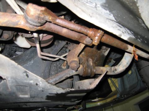 1991 Ford LTD Crown Victoria - Undercarriage view shows significant rust on suspension and steering linkage parts.