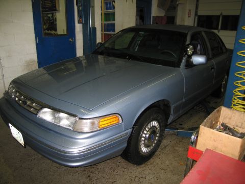 1991 Ford LTD Crown Victoria - A light blue 1991 Ford Crown Victoria is shown on a lift inside a garage.