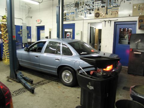 1991 Ford LTD Crown Victoria - A 1991 Ford Crown Victoria LTD is parked on a lift inside a service bay.