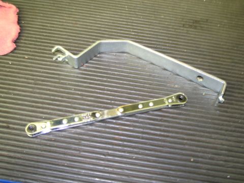 1991 Ford LTD Crown Victoria - Close-up of two specialized automotive tools, possibly for trim removal or adjustment, resting on a textured workbench.