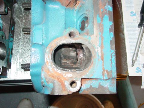 1979 Ford Bronco - This is a close-up view of an engine cylinder head, showing wear and rust around a port.