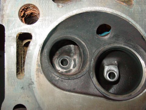 1979 Ford Bronco - Close-up of an engine cylinder head, revealing the condition of its valve seats and combustion chambers.